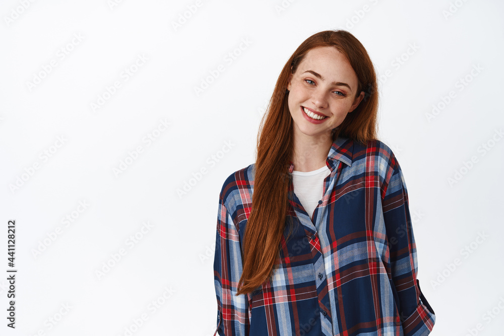 Portrait of cute and tender redhead woman with freckles, gazing with tenderness and heartwarming gentle feeling, smiling at camera, white background Portrait of cute and tender redhead woman with freckles, gazing with tenderness and heartwarming gentle feeling, smiling at camera, white background