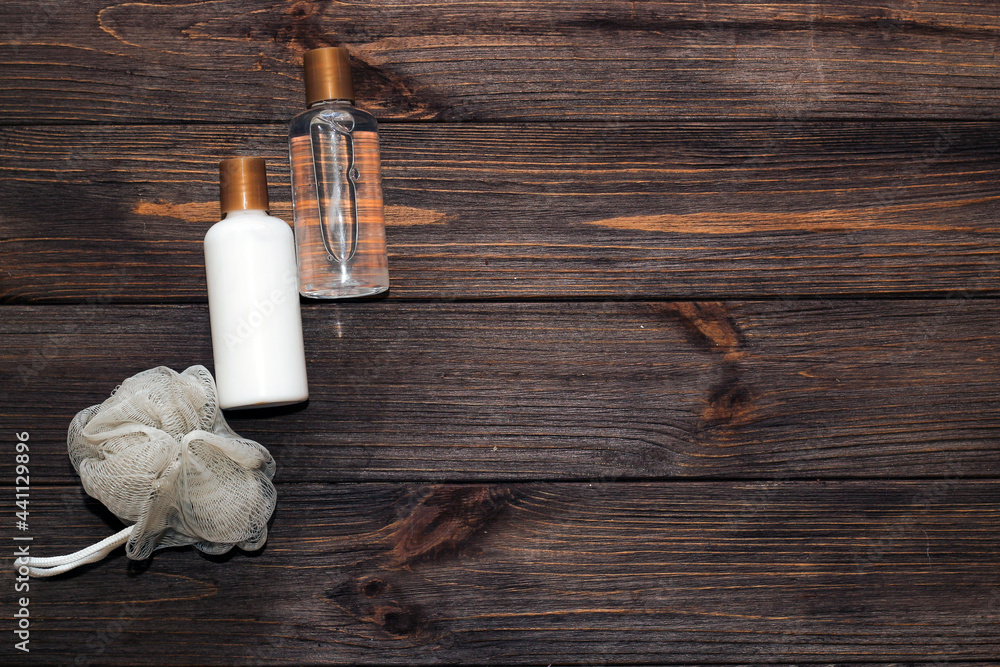 Cosmetic bottles for bathroom and washcloth on wooden background. Cosmetic bottles for bathroom and washcloth on wooden background.