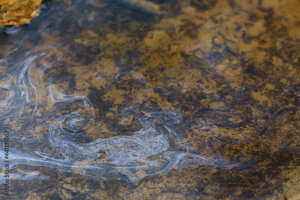 oil spills on puddle background, abstract gasoline nature pollution concept oil spills on puddle background, abstract gasoline nature pollution concept