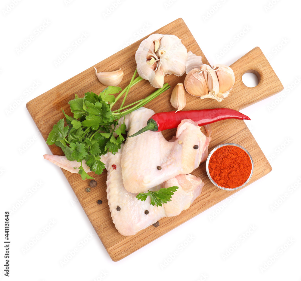 Raw chicken wings with spices and parsley on white background, top view Raw chicken wings with spices and parsley on white background, top view