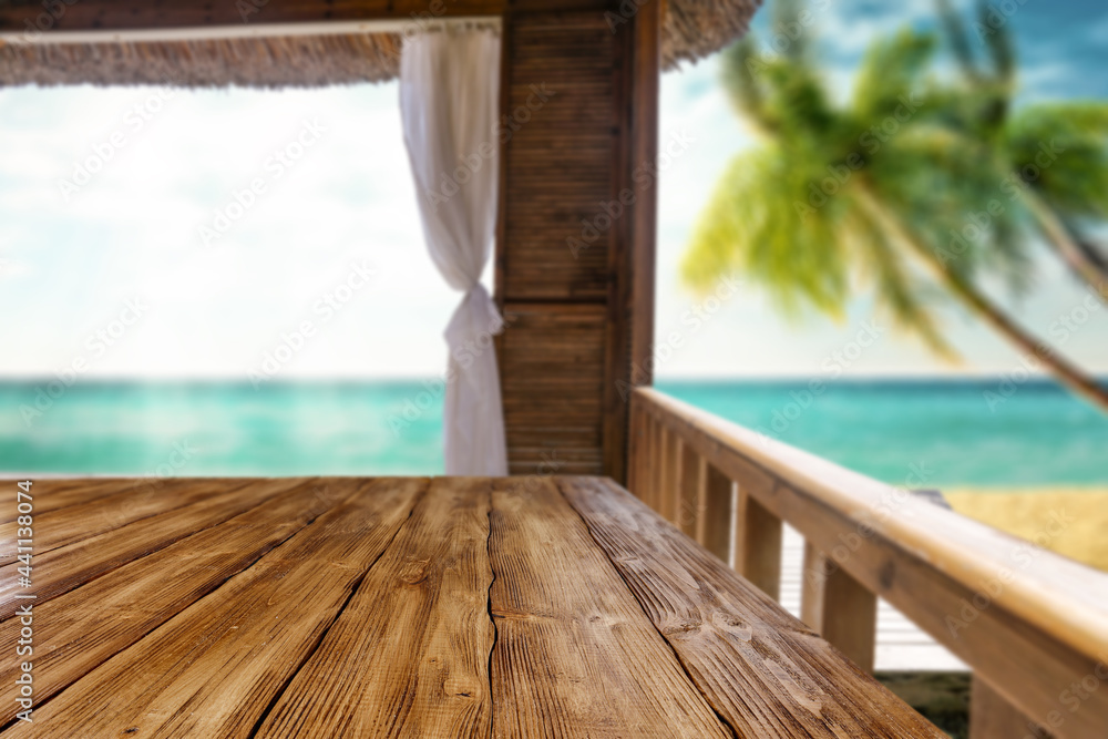 Wooden desk of free space and summer background of beach 