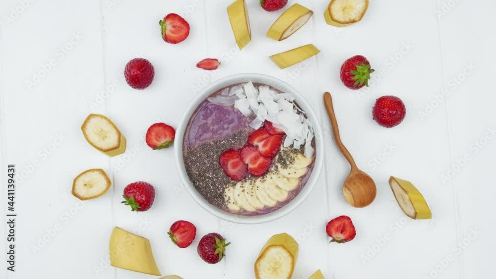 A bowl of vegetarian breakfast with strawberries, yogurt and chia seeds from a white wood table. Healthy food concept A bowl of vegetarian breakfast with strawberries, yogurt and chia seeds from a white wood table. Healthy food concept
