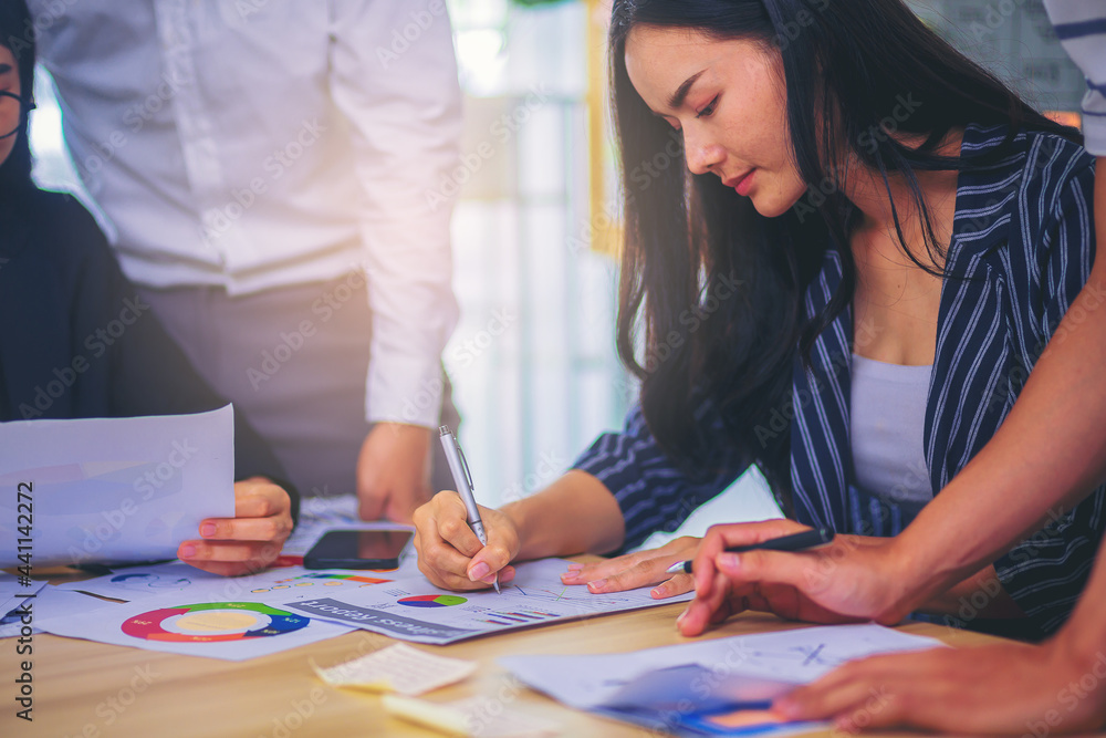 Business peoples meeting to analyze and discuss for situation on the marketing. Business collaboration concept. Selected focus Business peoples meeting to analyze and discuss for situation on the marketing. Business collaboration concept. Selected focus