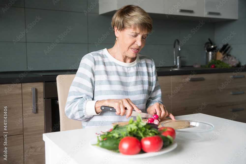 senior woman make salad for lunch at home. healthy diet. senior woman make salad for lunch at home. healthy diet.