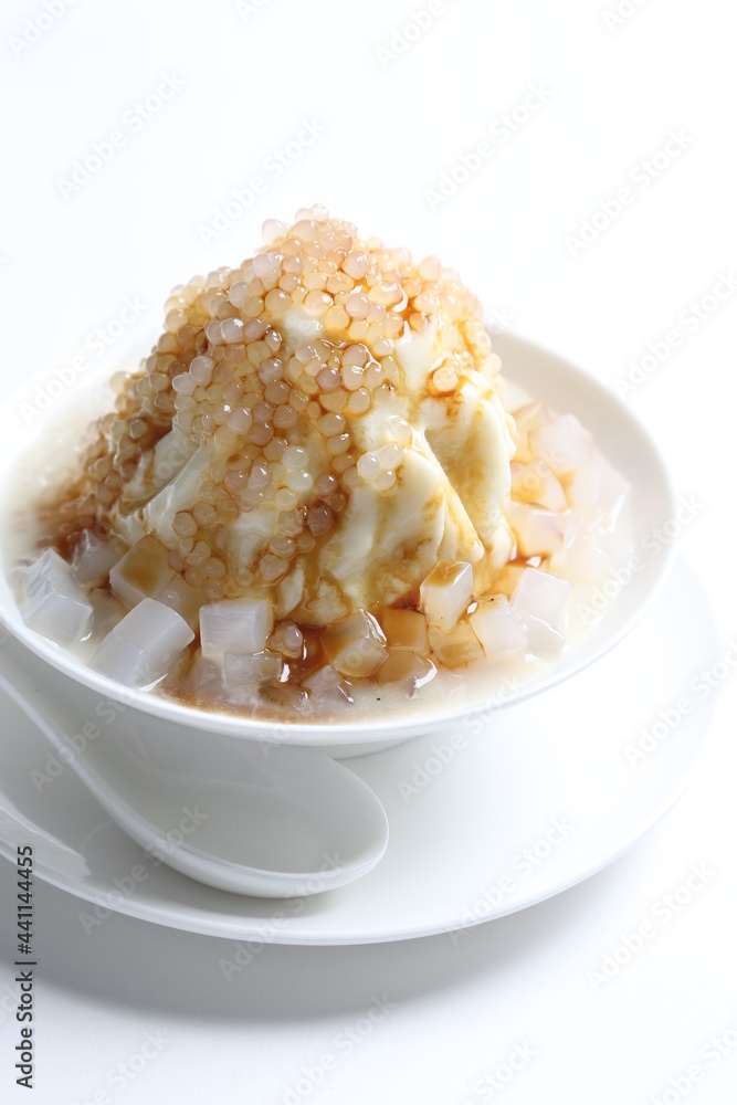 chilled soya pudding jelly with sea coconut sago ice snow kacang and brown sugar syrup in white bowl sweet dessert menu
