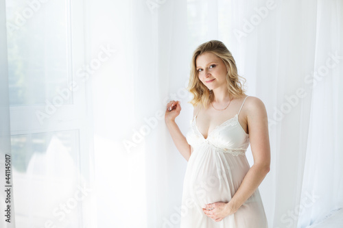 Portrait of happy pregnant woman at home