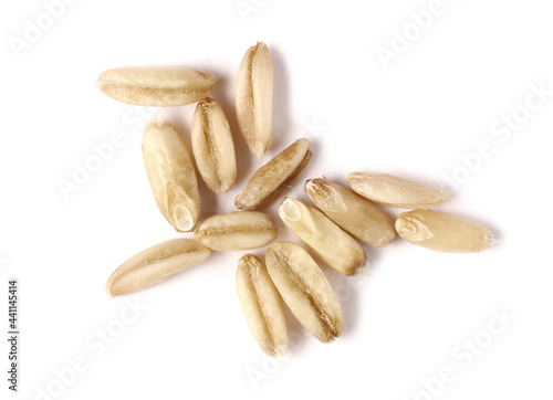 Peeled oat grains, groats pile isolated on white background, macro top view