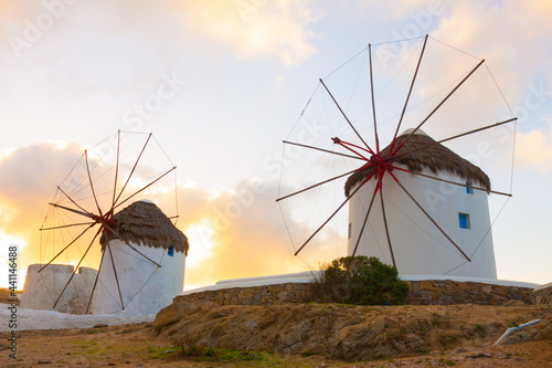 Windmills closeup with partialy blue sky and clouds in background Mykonos island cyclades Greece photo