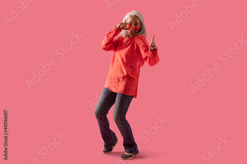 An old lady dancing being modishly dressed