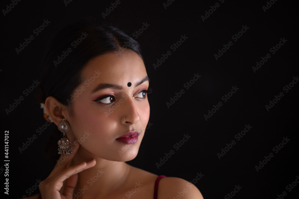 Fototapeta premium Portrait of a beautiful woman Against Black background