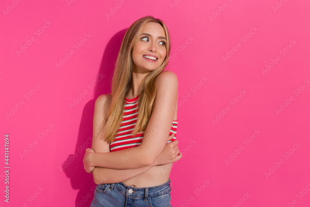 Young Woman In Striped Tank Top Is Posing With Arms Crossed And Looking Away Young Woman In Striped Tank Top Is Posing With Arms Crossed And Looking Away
