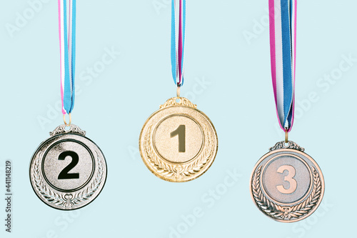 three medals (gold,silver,bronze) on blue background.concept of award and victory.copy space