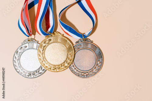 three medals (gold,silver,bronze) on pastel background.concept of award and victory.copy space