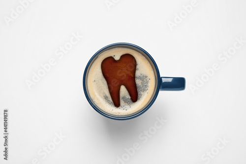Coffee causing dental problem. Cup of hot drink on white background, top view