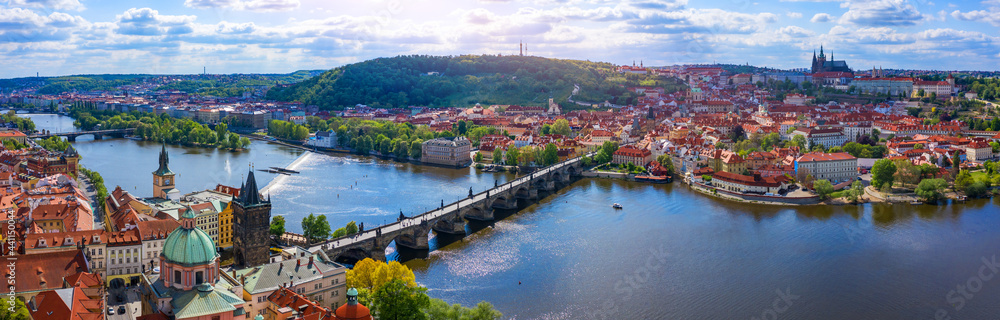 Fototapeta premium Prague scenic spring aerial view of the Prague Old Town pier architecture Charles Bridge over Vltava river in Prague, Czechia. Old Town of Prague with the Castle in the background, Czech Republic.