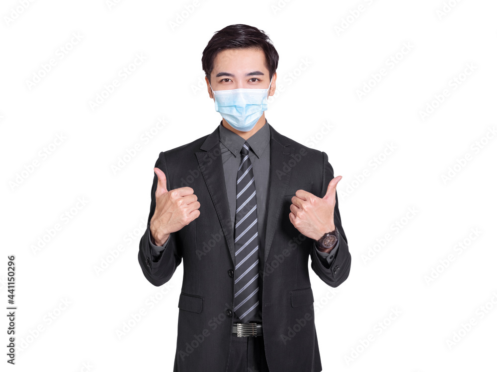 young businessman wearing medical mask, standing and showing thumbs up gesture young businessman wearing medical mask, standing and showing thumbs up gesture