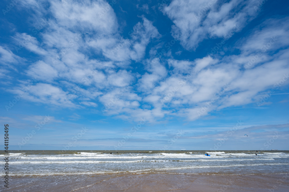 North sea waves and sandy beach in sunny day