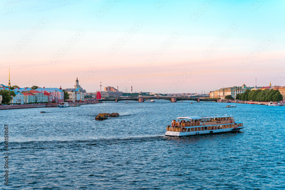 Summer panorama of the city and the river in St. Petersburg. Postcard view and the concept of river tourism at sunset
