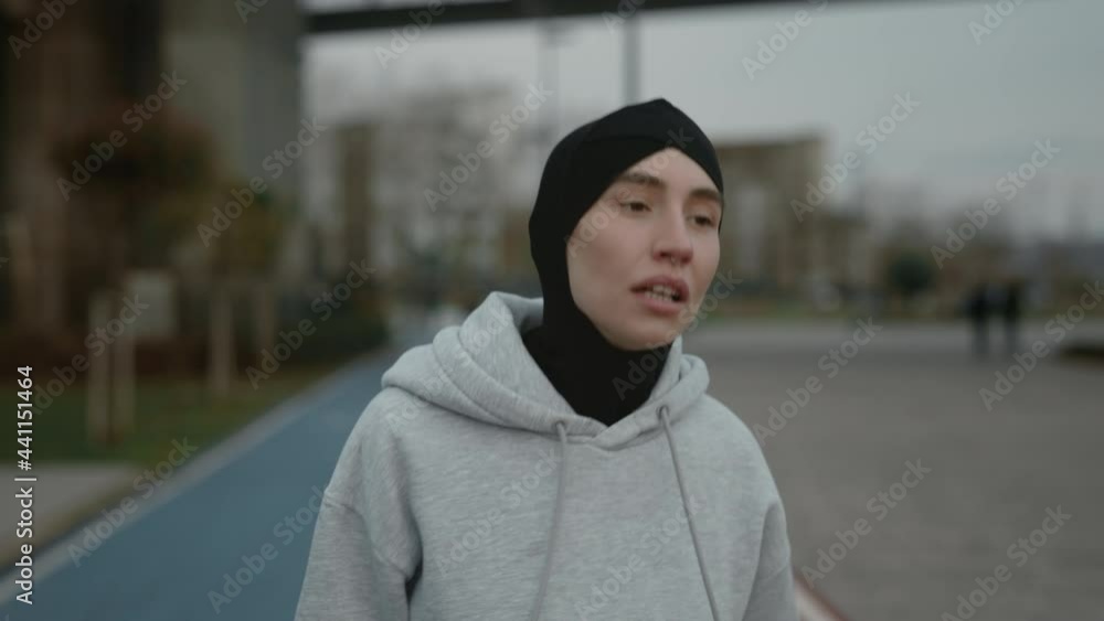 Woman in hijab and active clothes jogging outdoors Woman in hijab and active clothes jogging outdoors