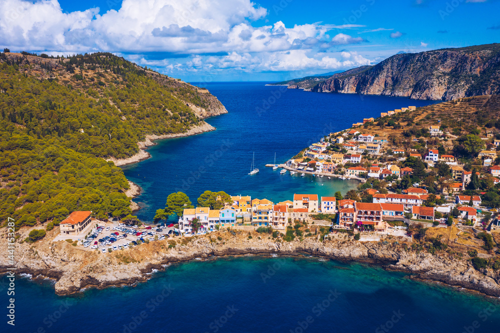 Aerial drone view video of beautiful and picturesque colorful traditional fishing village of Assos in island of Cefalonia, Ionian, Greece. Peninsula of Assos in Cephalonia (Kefalonia), Greece