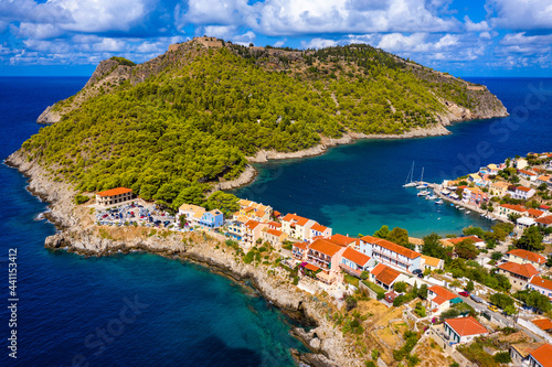 Aerial drone view video of beautiful and picturesque colorful traditional fishing village of Assos in island of Cefalonia, Ionian, Greece. Peninsula of Assos in Cephalonia (Kefalonia), Greece