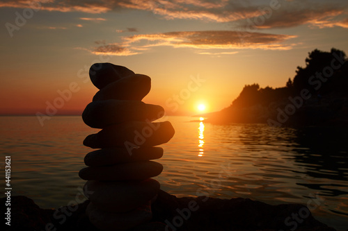 Zen stones on a ocean sea cliff in sunset sunrise time.