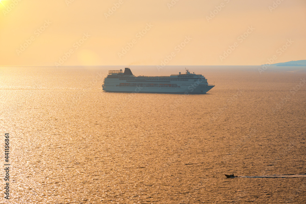 Cruise ship silhouette in Aegean sea on sunset