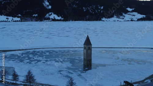 Aerial footage drone view of tower Curon Venosta ice lake, Italy // no video editing