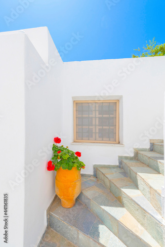 Greece Santorini island in Cyclades, traditional sights of colorful and white washed houses with wooden frames and flowers