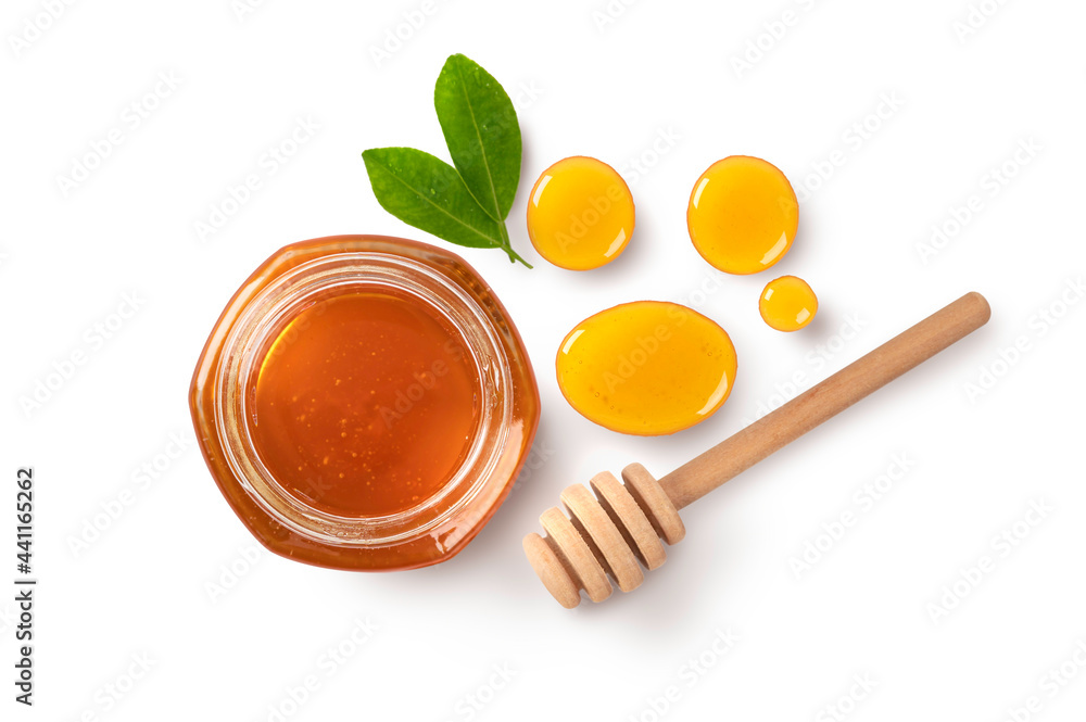 Honey in glass jar with dipper and leaves isolated on white background. Honey in glass jar with dipper and leaves isolated on white background.