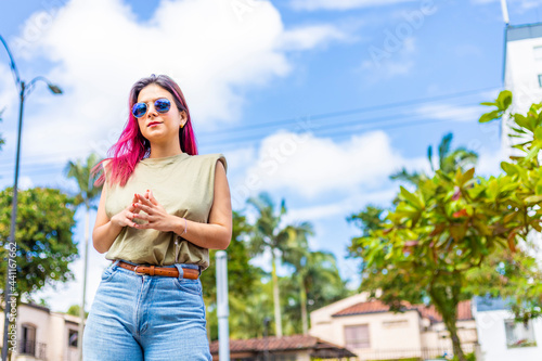 latina woman in urban environment with fingers together. Concept of non-verbal communication