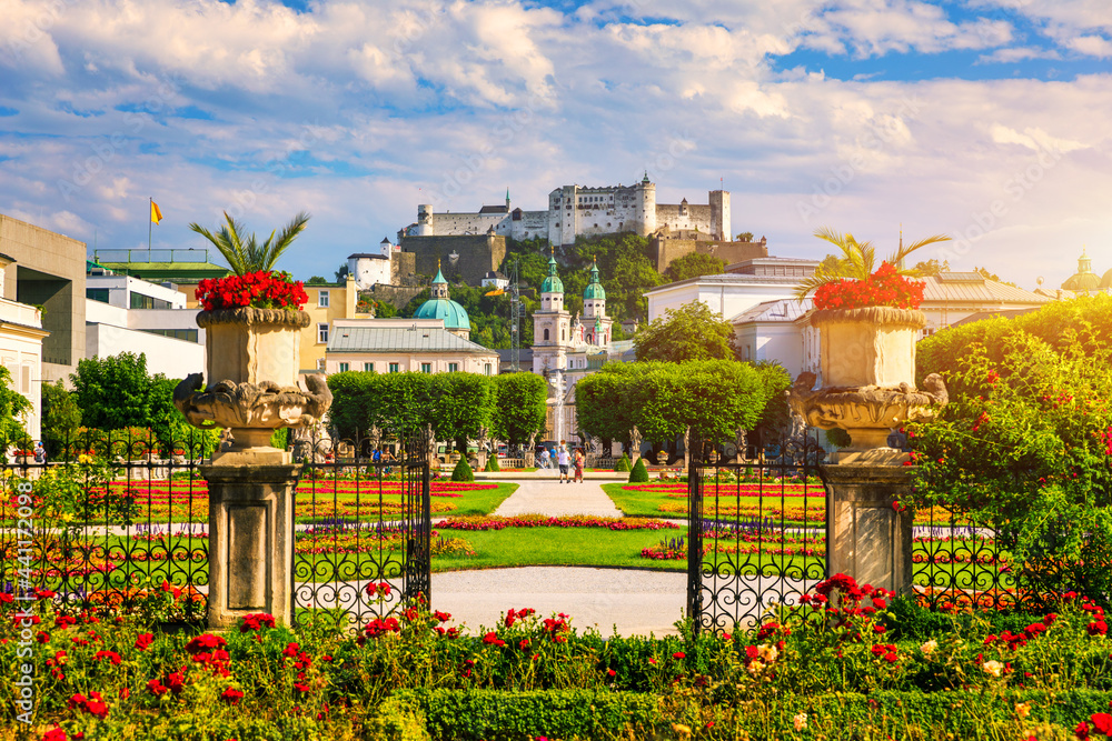 Fototapeta premium Beautiful view of famous Mirabell Gardens with the old historic Fortress Hohensalzburg in the background in Salzburg, Austria. Famous Mirabell Gardens with historic Fortress in Salzburg, Austria.