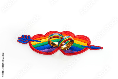 Love wins concept with a multicolored heart and wedding rings. Equality and love protection