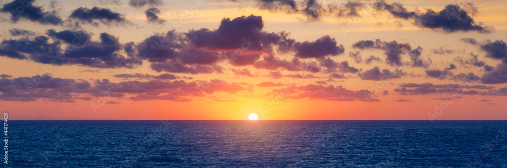 Beautiful sunset/sunrise over the sea. Beautiful sunset over the ocean. Beautiful sunset over sea with reflection in water, majestic clouds in the sky