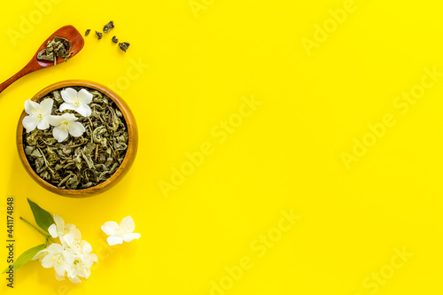 Jasmine hearbal tea in bowl with flowers. Overhead view