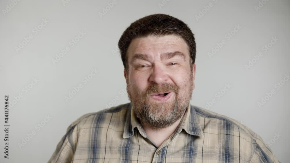 Handsome unshaven bearded aged man in gray blue shirt isolated over gray background in studio. People sincere emotions, lifestyle concept. Looking at camera scream rejoice win happy Handsome unshaven bearded aged man in gray blue shirt isolated over gray background in studio. People sincere emotions, lifestyle concept. Looking at camera scream rejoice win happy