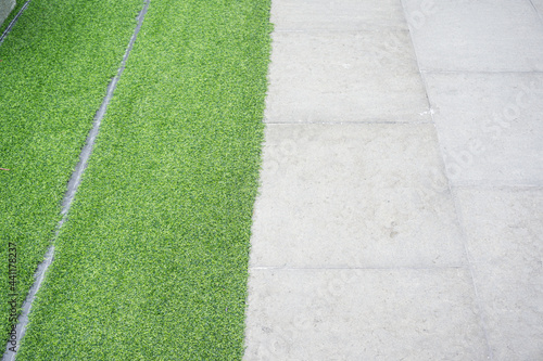 Green grass on cement pathway exterior decoration © themorningglory