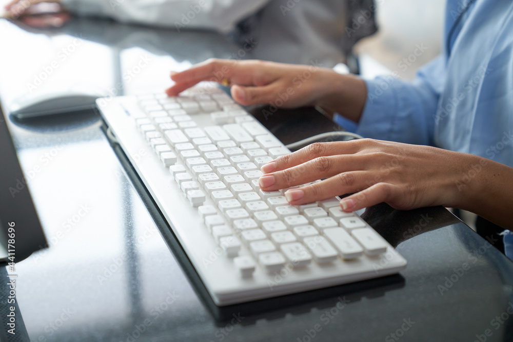 Focus on hand of woman call center typing on keyboard for support customer