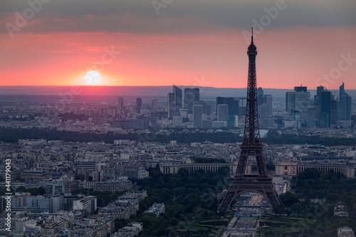 View of Paris with Eiffel Tower from Montparnasse building. Eiffel tower view from Montparnasse at sunset, view of the Eiffel Tower and La Defense district in Paris, France. © daliu