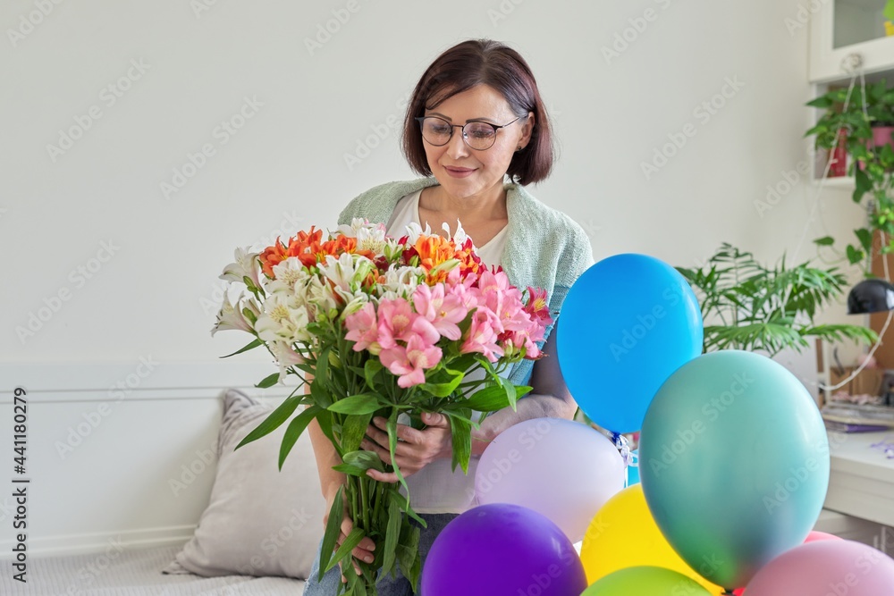 Birthday, 45 years old, happy female with bouquet of flowers and balloons Birthday, 45 years old, happy female with bouquet of flowers and balloons