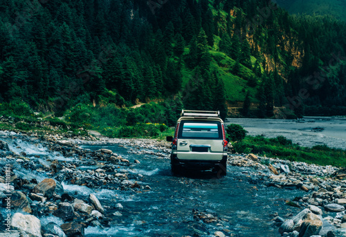 Off road car on the water fall in the mountain