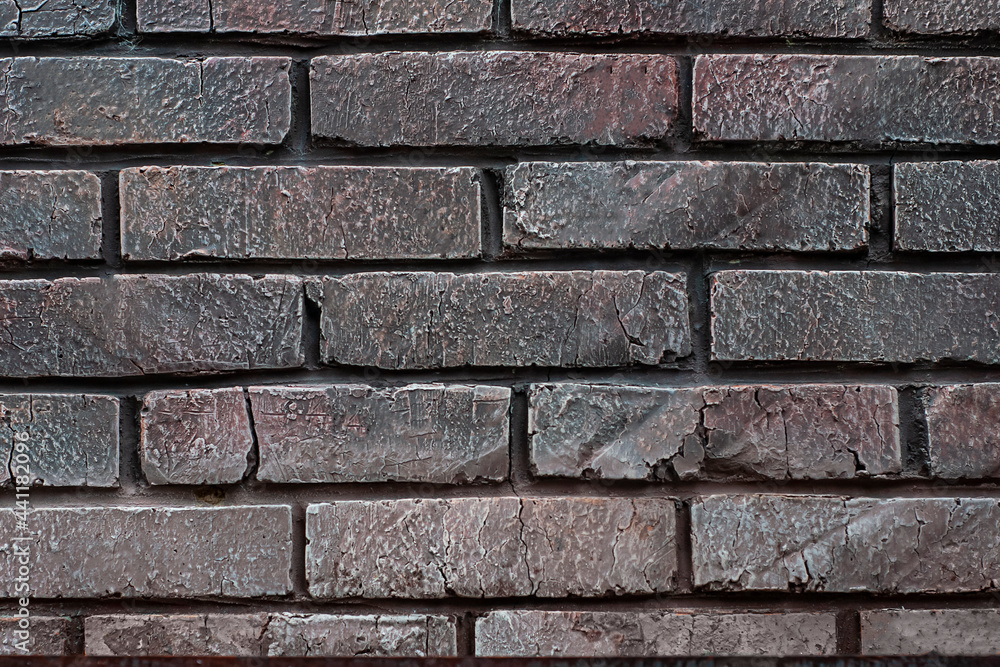 Fototapeta premium The texture of a stone wall. Background texture of the stone wall of an old building. Part of a brick wall as a background or texture. High quality photo