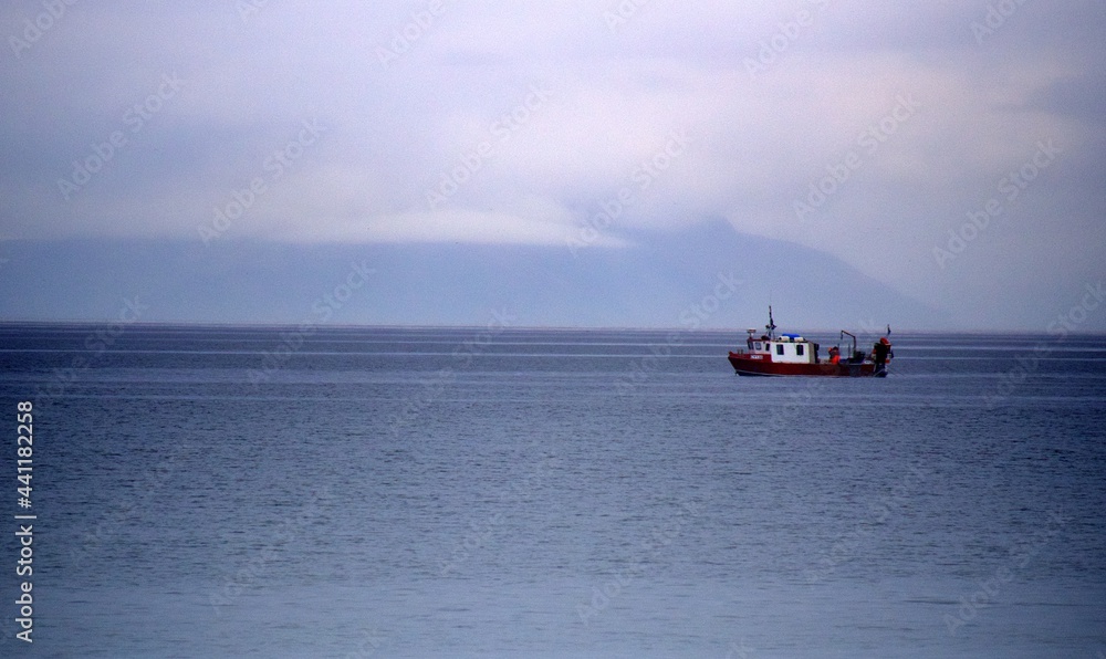 Fishing boat off the coast at Prestwick on a rainy day 