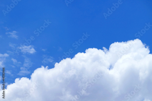 Pure white fluffy cumulus clouds on vivid blue sky 