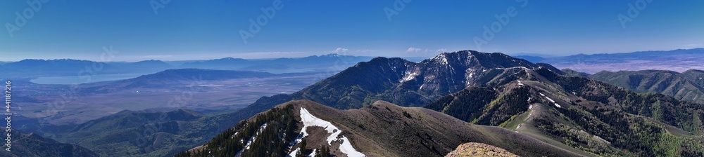 Fototapeta premium Rocky Mountains Lowe Peak views of Oquirrh range toward Utah Lake, Timpanogos, Wasatch Front by Rio Tinto Bingham Copper Mine, in spring. Utah. United States. USA.