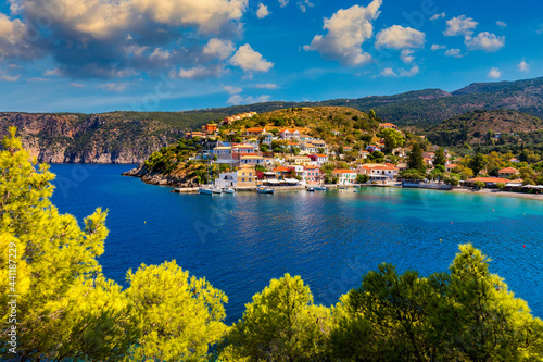 Assos village in Kefalonia, Greece. Turquoise colored bay in Mediterranean sea with beautiful colorful houses in Assos village in Kefalonia, Greece, Ionian island, Cephalonia, Assos village.