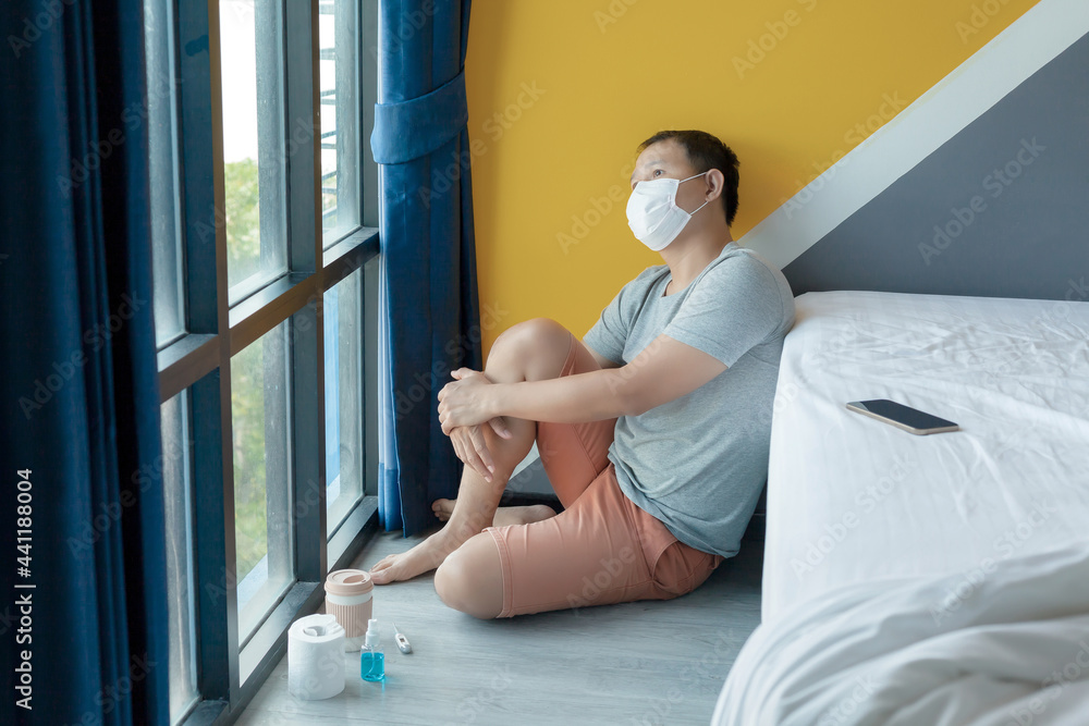 Fototapeta premium Sad men sitting alone.Cropped shot of anxious worried men sitting on bed at home.Frustrated confused male feels unhappy, sadness because worry about problem of coronavirus. Covid-19 problem concept..