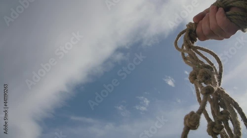 Man holding a rope whip in his hand. Jesus expels the temple sellers.