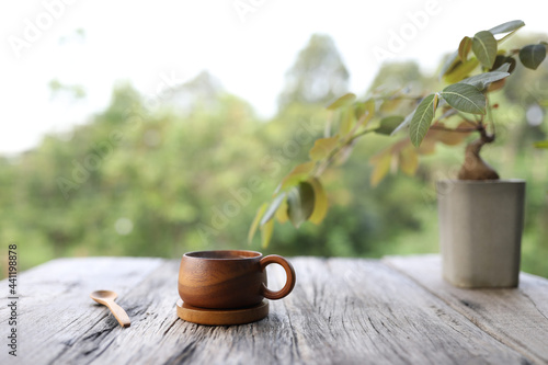 wooden coffee cup with spoon and Caudiciform Plants on wooden table photo