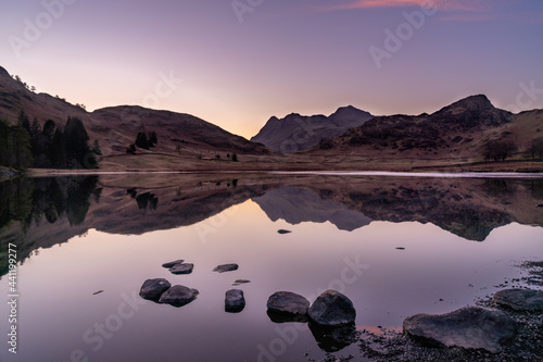 Blea Tarn Sunset with the reflections in the water.  Lake District National Park, England.